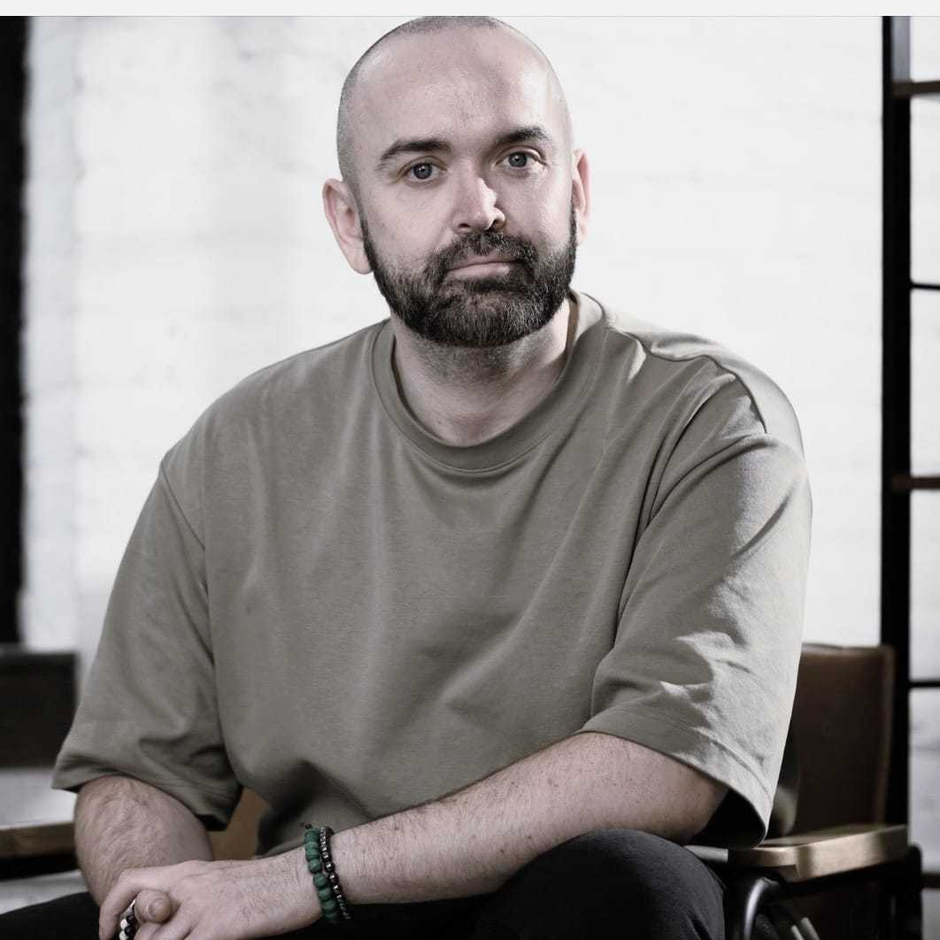Portrait of Anthony Caresmel, a professional stylist at Salon Savoir, showcasing their expertise and style.