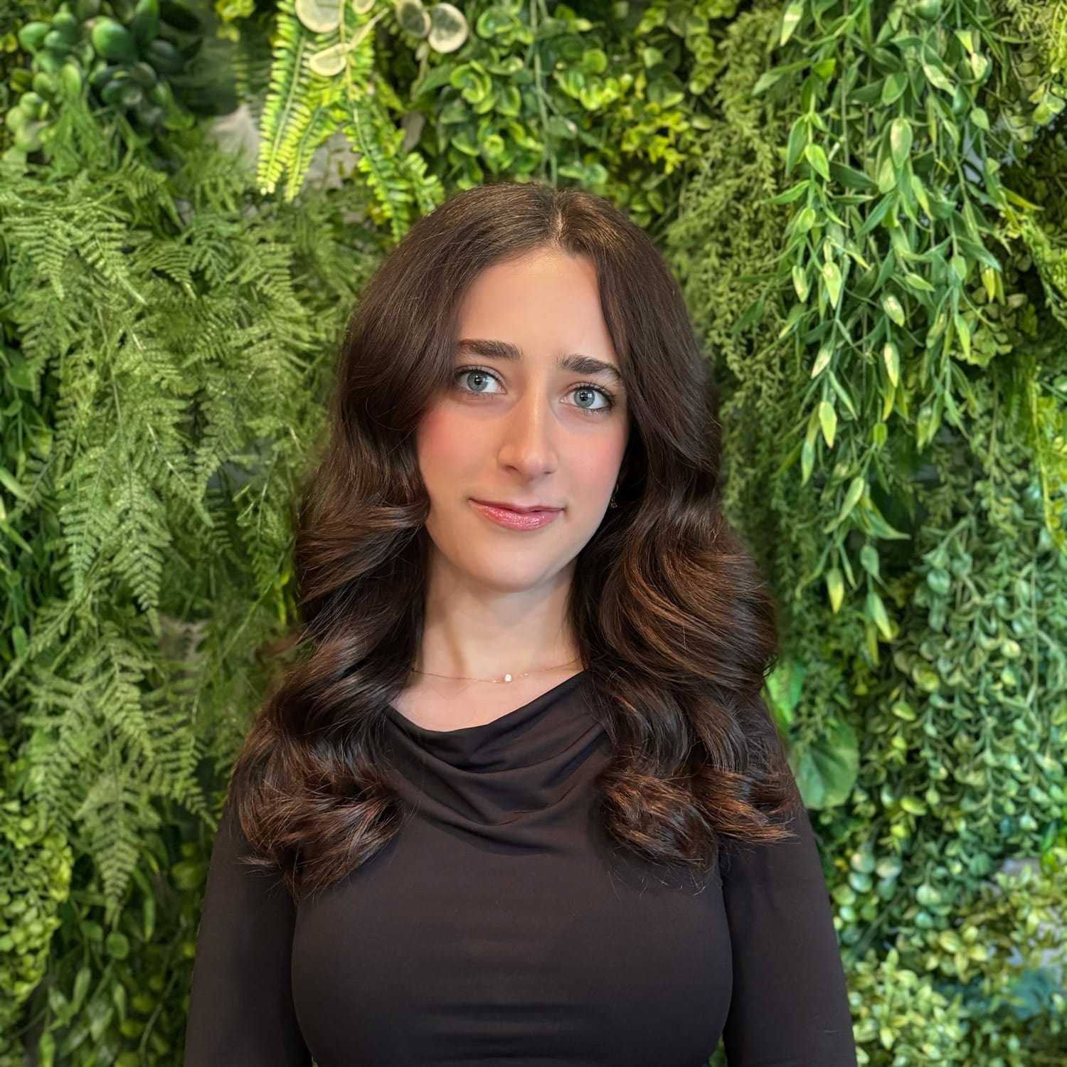 Portrait of Chrestina Khosho, a professional stylist at Salon Savoir, showcasing their expertise and style.