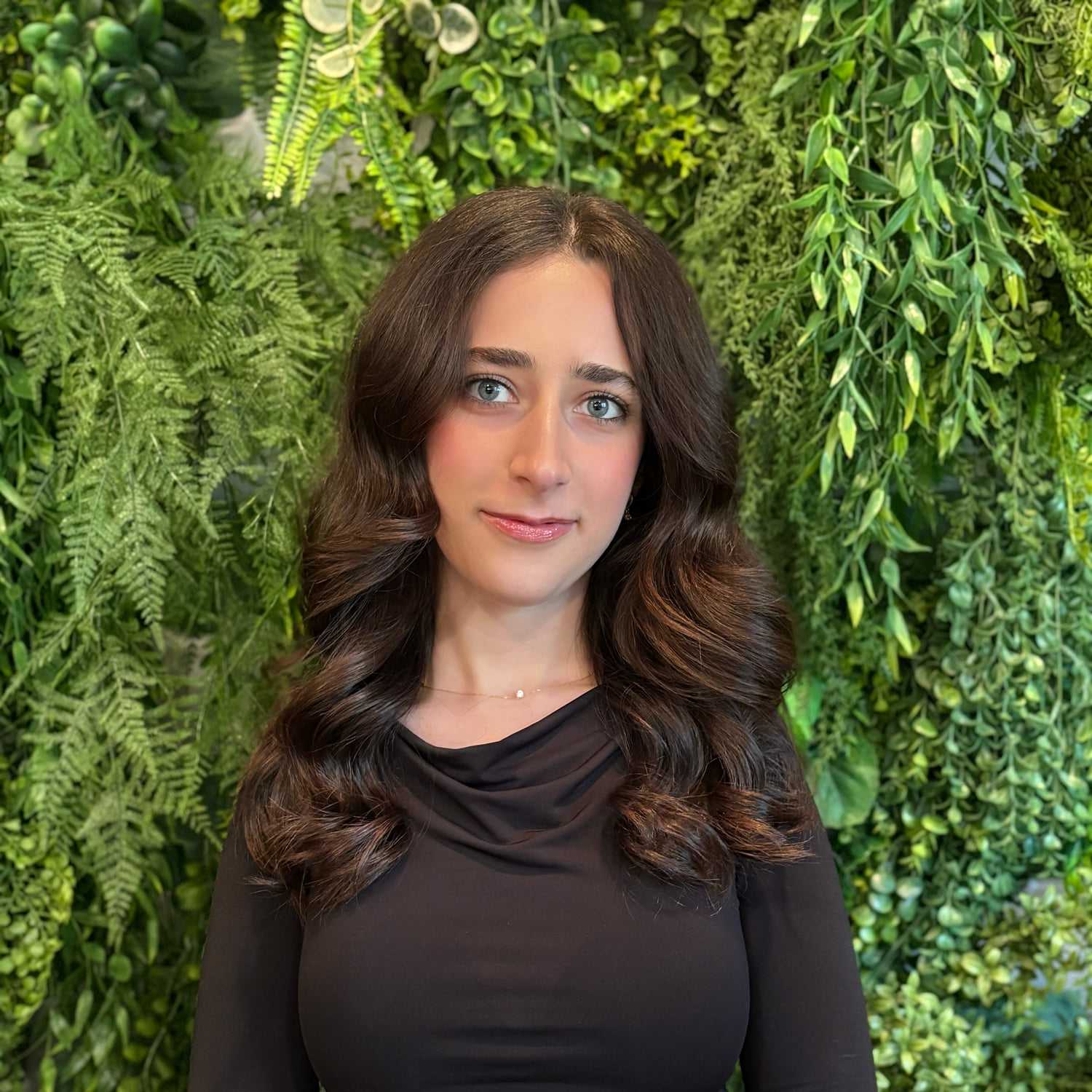 Portrait of Chrestina Khosho, a professional stylist at Salon Savoir, showcasing their expertise and style.